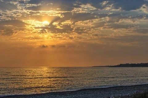 Sunset over the sea and beach Stock Photos