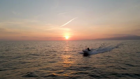 Sunset over the sea chasing the boat Video stock 241680229
