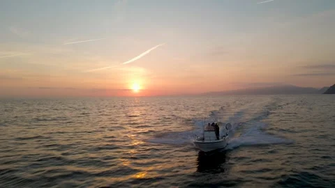 Sunset over the sea chasing the boat Stock Footage 241680343
