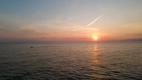 Sunset over the sea chasing the boat Stock Footage 241680347