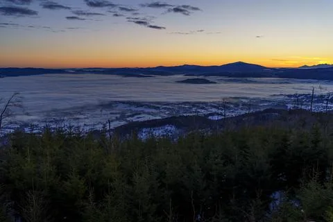 Sunset over sea of clouds in mountain valley Stock Photos