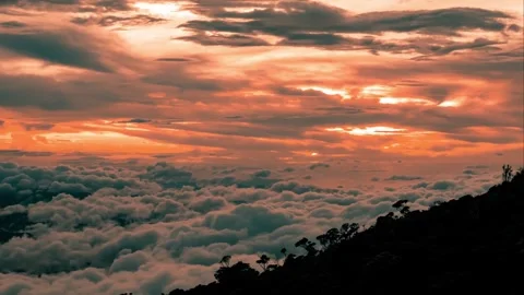 Sunset Over a Sea of Clouds from a Mountaintop Stock Footage 297525819