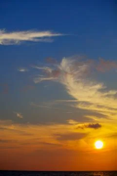 Sunset over sea with dramatic clouds Stock Photos