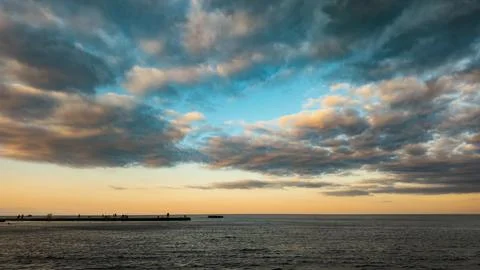 Sunset over sea with dramatic clouds Stock Photos