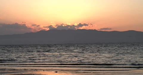 Sunset over the sea in the Ebro Delta. The sun sets behind the mountain Stock Footage 151351972