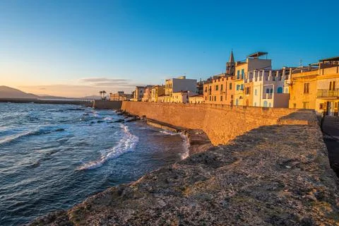 Sunset over the sea front in Alghero (L'Alguer), province of Sassari , Sardin Stock Photos