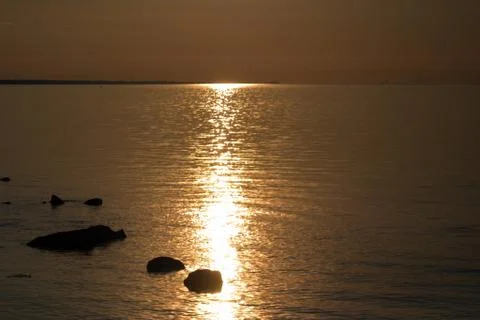Sunset over the sea. Reflection of sunlight in the water. Gulf of Finland. 스톡 사진