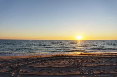 Sunset over the sea. Reflection of sunlight in the sea waves. The sky in the  Stock Photos