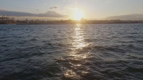 Sunset over the sea. Shot on a drone. A golden idyllic sunset as the sun sets Video stock 129616555
