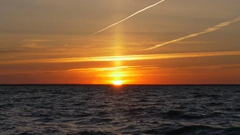 Sunset over sea, sun beam on orange sky Stock Footage 77106061