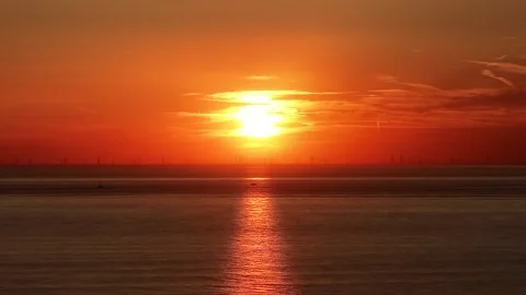 Sunset over the sea. Sun dropping behind the horizon at golden hour. Stock Footage 317683189