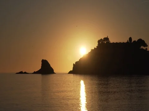 Sunset over the sea. Sun setting behind the mountain. 40x timelapse Stock Footage 82499496