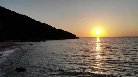 Sunset Over The Sea. Sun Setting Behind The Cliff Drone Shot Video stock 138080399
