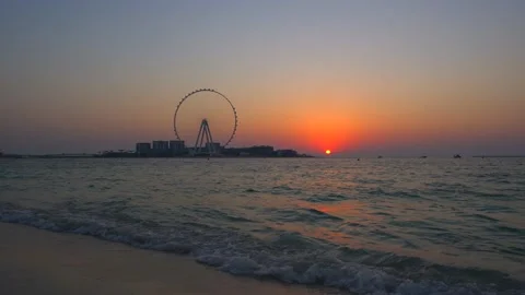 Sunset over the sea view to the Dubai Eye giant Ferris Stock Footage 140744965