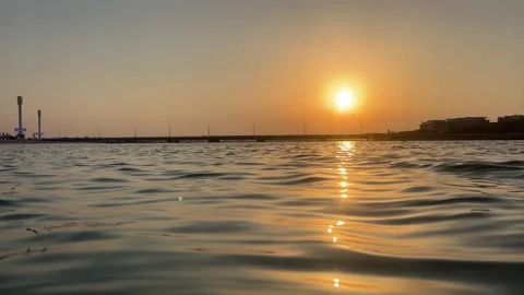 Sunset over the sea. Water surface with a golden light reflecting on gentle.. Stock-Footage 338321099