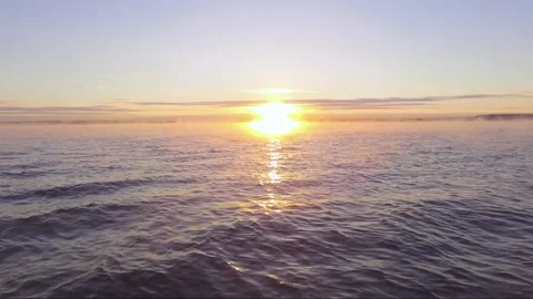 Sunset over the sea. Waves of the sea. Fog and vapors over the water 스톡 동영상 145880484