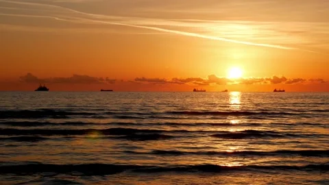 Sunset over the sea, waves, ships, horizon ocean landscape video. Stock Footage 323007404