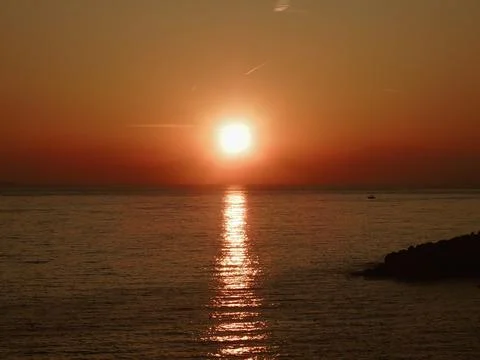 Sunset over the sea in winter Stock Photos