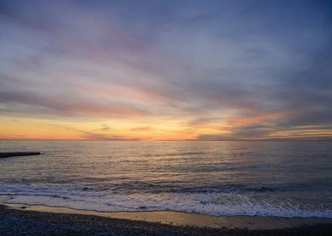 Sunset over the sea in winter Stock Photos