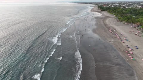 Sunset over Seminyak Beach in Bali creates a mesmerizing scene with golden .. Stock Footage 299030286