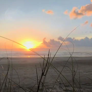Sunset over the serene beach Stock Photos