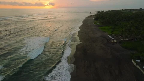 Sunset Over Serene Black Sand Beach, a tranquil spot for relaxation Stock Footage 280251240