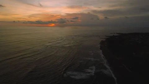 Sunset Over Serene Black Sand Beach, a tranquil spot for relaxation Stock Footage 280546645