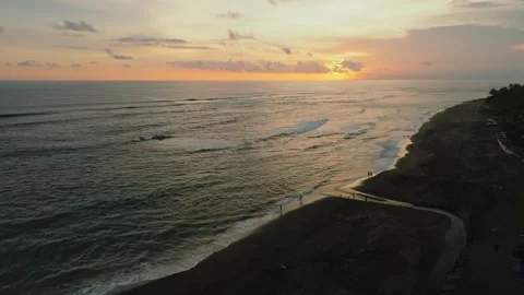 Sunset Over Serene Black Sand Beach, a tranquil spot for relaxation Stock Footage 280546669