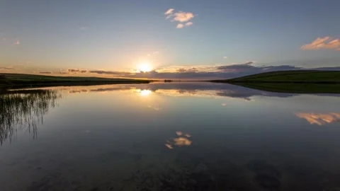 Sunset over the Skaill Loch with mirror reflections 4k Time lapse Stock Footage 253323312