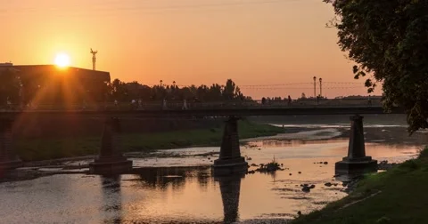 Sunset Over Small City River With Pedestrian Bridge, Transition From Day to Video stock 67555163