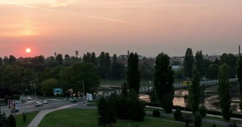 Sunset Over Small City River and a Bridge Over It, Car Traffic Transition From 스톡 동영상 67566706