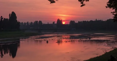Sunset Over Small City River and a Bridge Over It, Car Traffic Transition From 動画素材 67616302