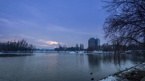 Sunset over a small lake in Bucharest, Romania, with heavy winter clouds Stock Footage 45986841