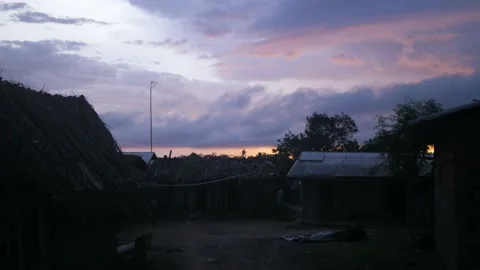 Sunset over a small typical farmer's village without electricity, in Ivory Coast Stock Footage 237969015