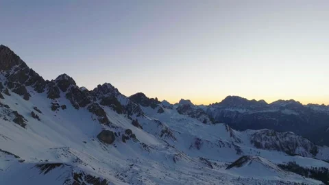 Sunset over the snow-capped Dolomites in the Italian Alps Stock Footage 233974272