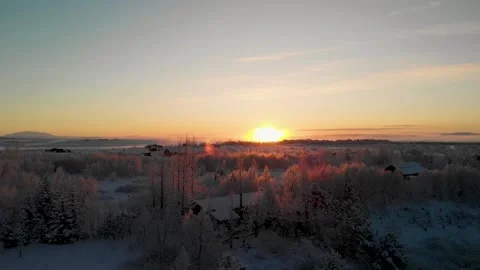 Sunset over snow covered cottages in Iceland Stock Footage 260599571
