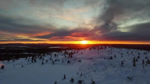 Sunset over snow covered forest and mountain top in winter Lapland, drone video Stock Footage 301331760