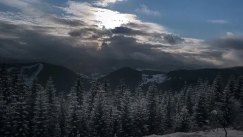 Sunset over snow-covered treetops, winter cloudy landscape Stock-Footage 146050377
