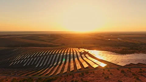 Sunset over a solar farm in a rural area highlighting renewable energy and land Stock Footage 344775987