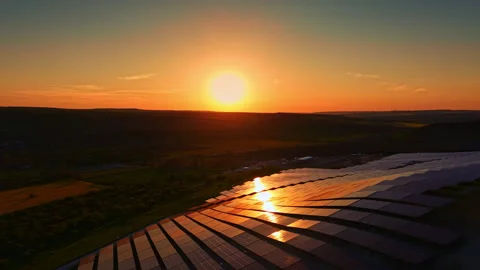 Sunset over solar panels highlighting renewable energy development in a rural Stock Footage 342516519
