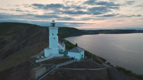 Sunset over Start Point Lighthouse, Trinity House and South West Coast Path, UK Stock-Footage 246599915