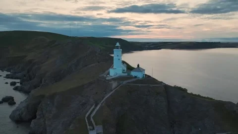 Sunset over Start Point Lighthouse, Trinity House and South West Coast Path, UK Stock Footage 246602025