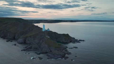 Sunset over Start Point Lighthouse, Trinity House and South West Coast Path, UK Stock-Footage 246602130