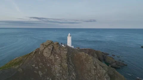 Sunset over Start Point Lighthouse from a drone, Trinity House, Devon, England 動画素材 261042648