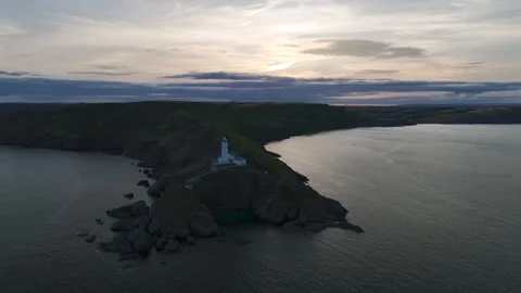 Sunset over Start Point Lighthouse from a drone, Trinity House, Devon, England 動画素材 261042709