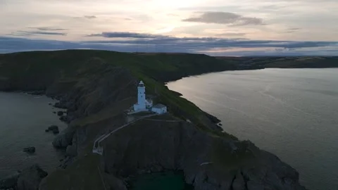 Sunset over Start Point Lighthouse from a drone, Trinity House, Devon, England 動画素材 261042869