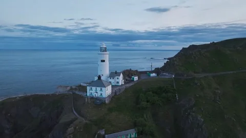 Sunset over Start Point Lighthouse from a drone, Trinity House, Devon, England 動画素材 261043061