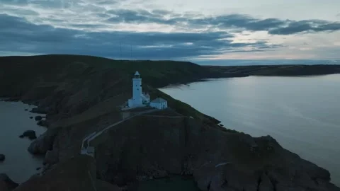 Sunset over Start Point Lighthouse from a drone, Trinity House, Devon, England 動画素材 261043373