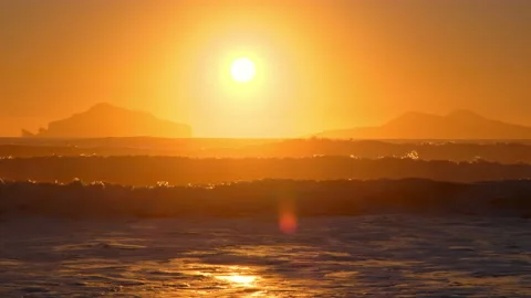 Sunset over Stormy Sea, Shining Golden Waves with Sun Reflection 8K Resolution Stock Footage 232307948