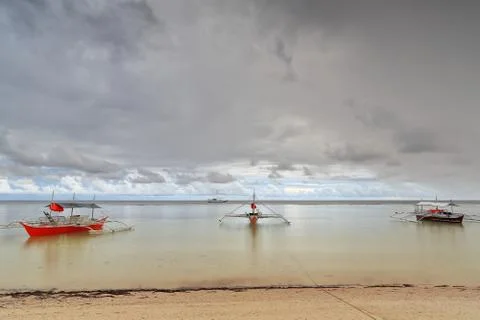 Sunset over stranded balangay or bangka boats. Punta Ballo beach-Sipalay-PH 0350 Stock Photos